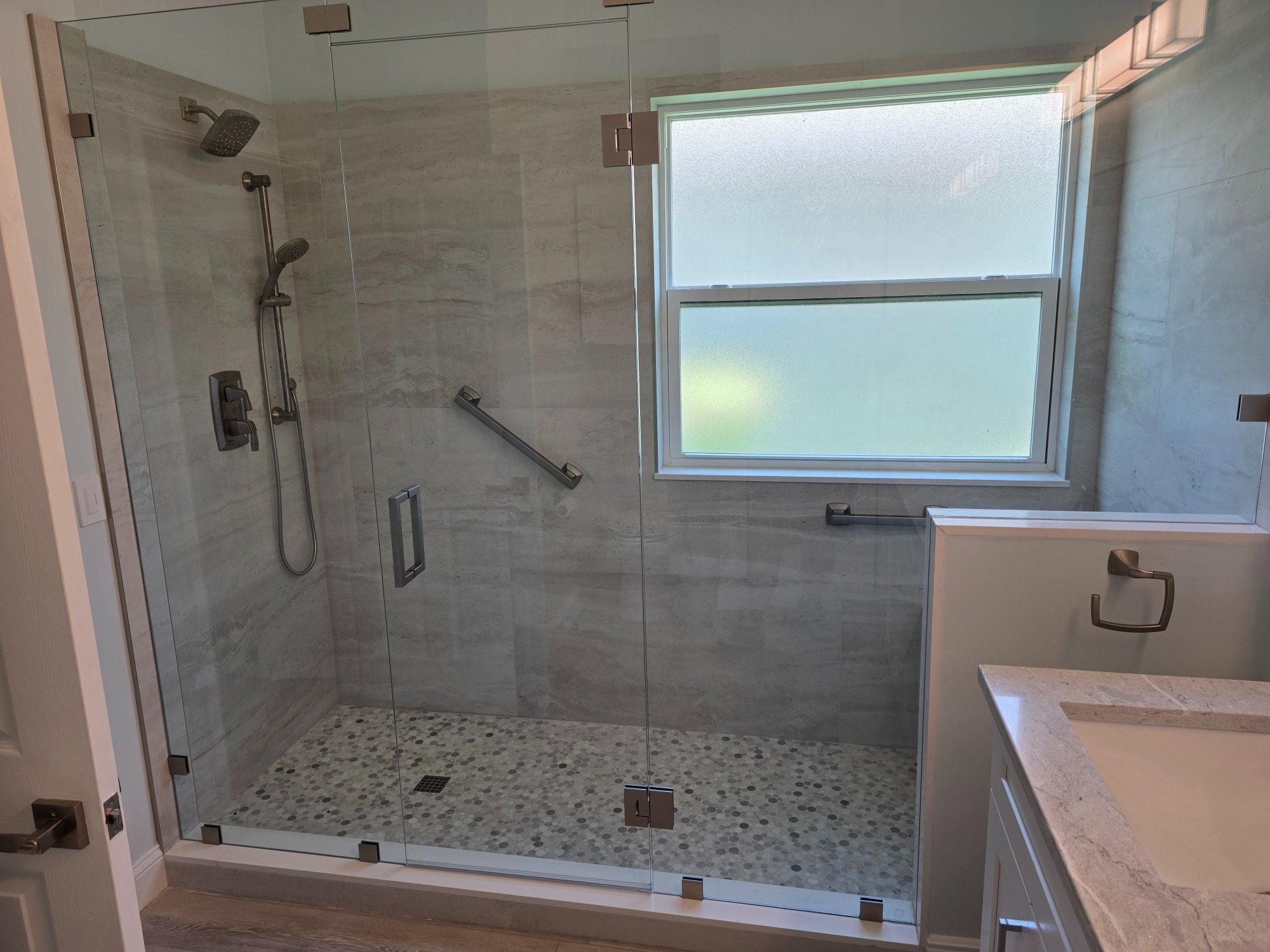 Ann's new walk-in shower Boynton Beach β frameless glass penny tile